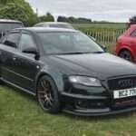 Dark green Audi RS4 B7 front three-quarter view