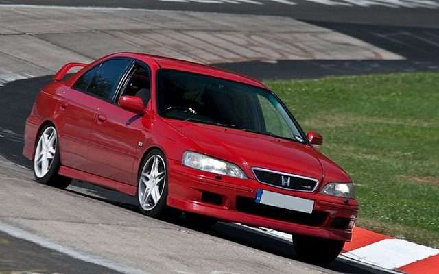 Red Honda Accord Type R driving on a circuit