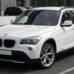 Pre-facelift E84 xDrive18d five-door SUV, front three-quarter view