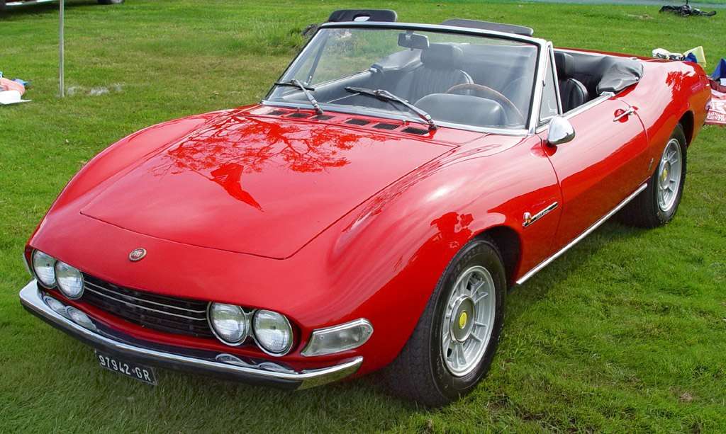 Red Fiat Dino 2400 Spider displayed indoors