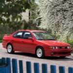 Red Nissan Primera P10 eGT front three-quarter view