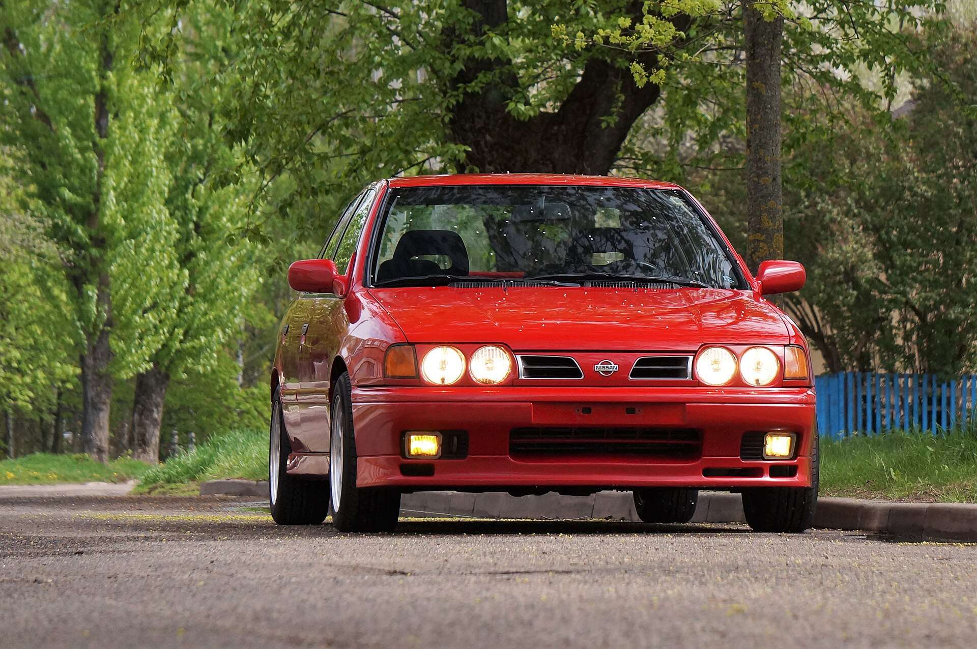 Red Nissan Primera P10 eGT side view