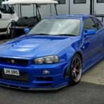 Blue Nissan Skyline GT-R R34 front three-quarter view