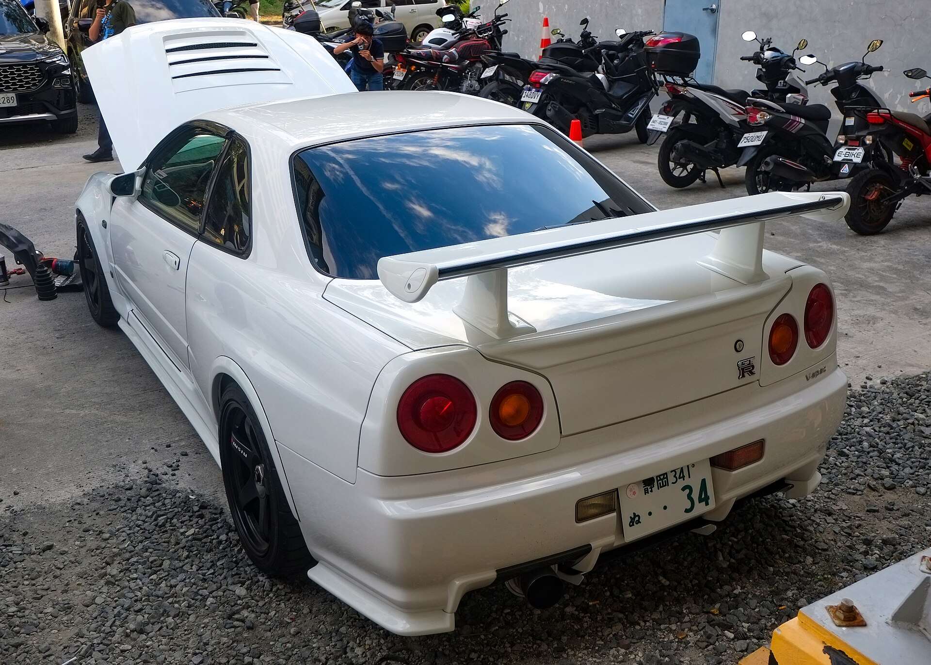 White Nissan Skyline GT-R R34 V-Spec rear three-quarter view