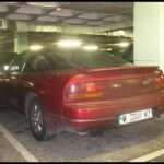 Red Nissan 200SX S13 fastback rear three-quarter view