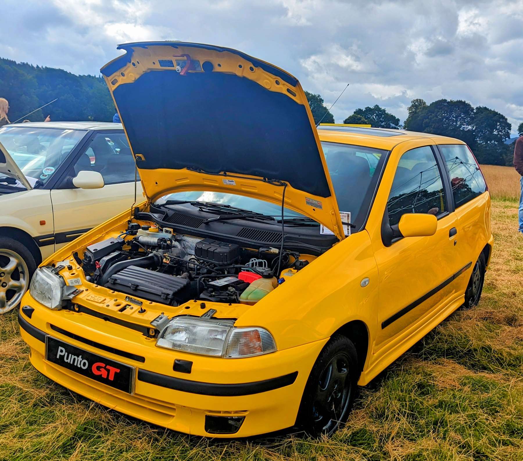 Yellow Fiat Punto GT with its bonnet open showing the turbo engine bay