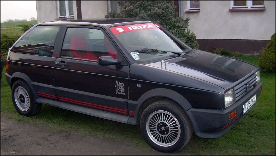 Black SEAT Ibiza SXI front three-quarter view