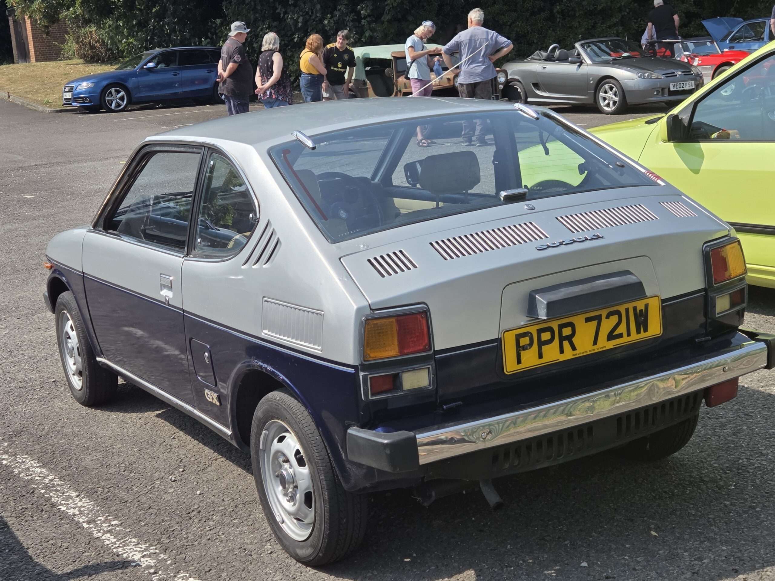 Red 1981 Suzuki SC100 front three-quarter view