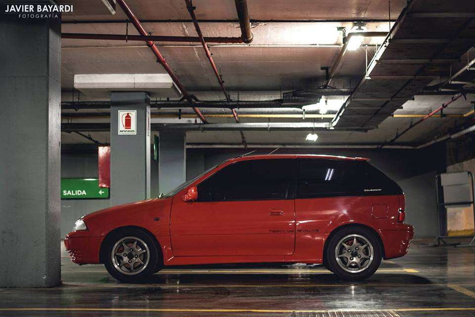 Red Suzuki Swift GTi Mk3 at a car show