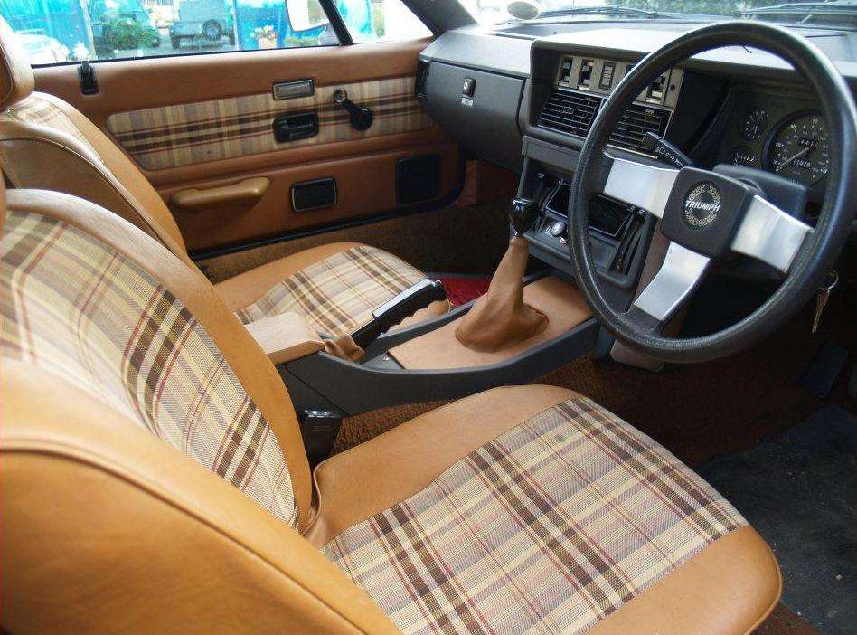 Plaid-trimmed Triumph TR7 dashboard and cabin