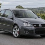 Dark grey Volkswagen Golf GTI Mk5 on a British country road